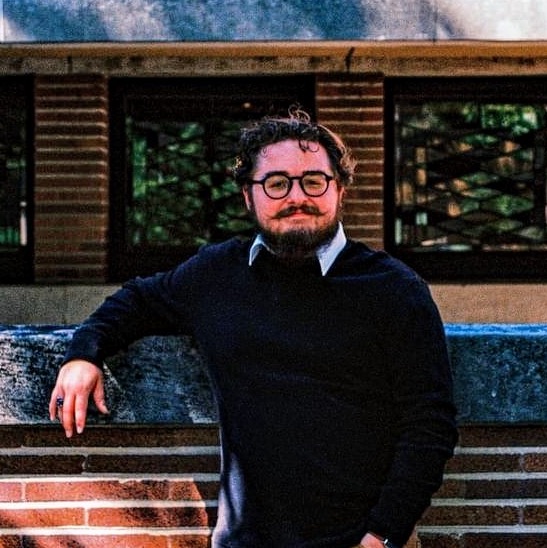 Young man with beard and glasses outdoors